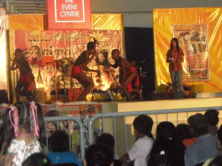 Agtas performing on stage at a shopping center